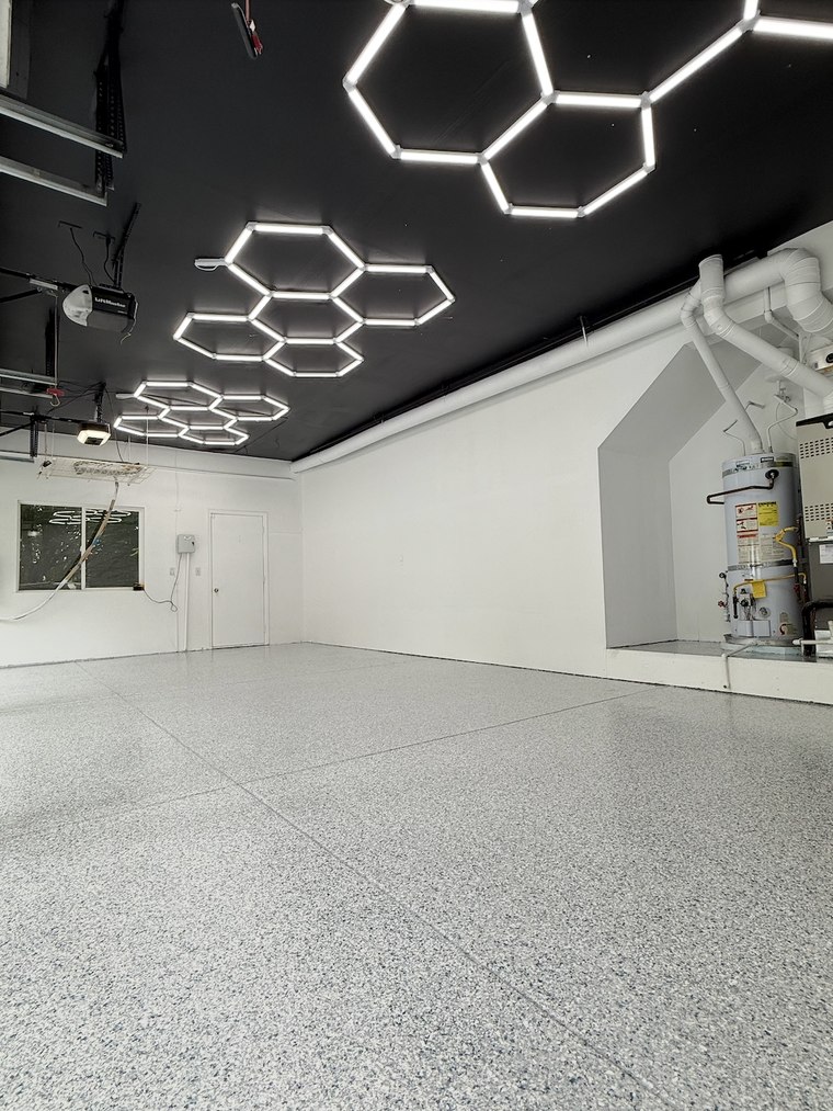 After garage renovation with painted walls and speckled flake epoxy floor by Seattle Artisan Studio